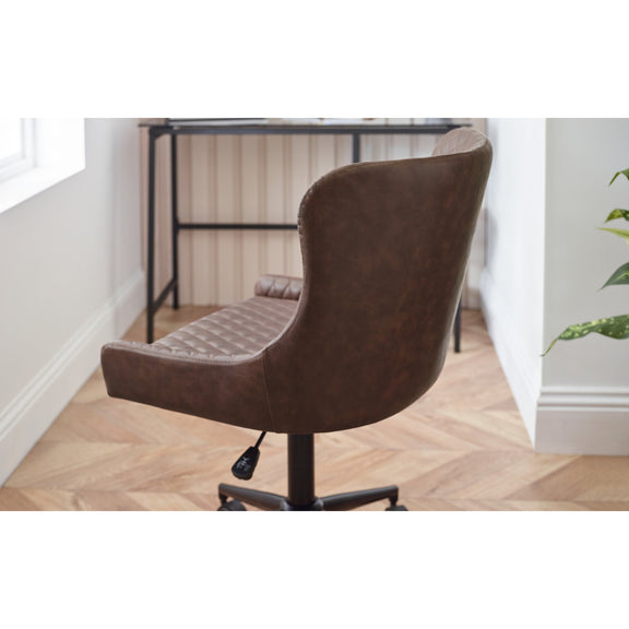 Brown office chair in a room with a desk and window.