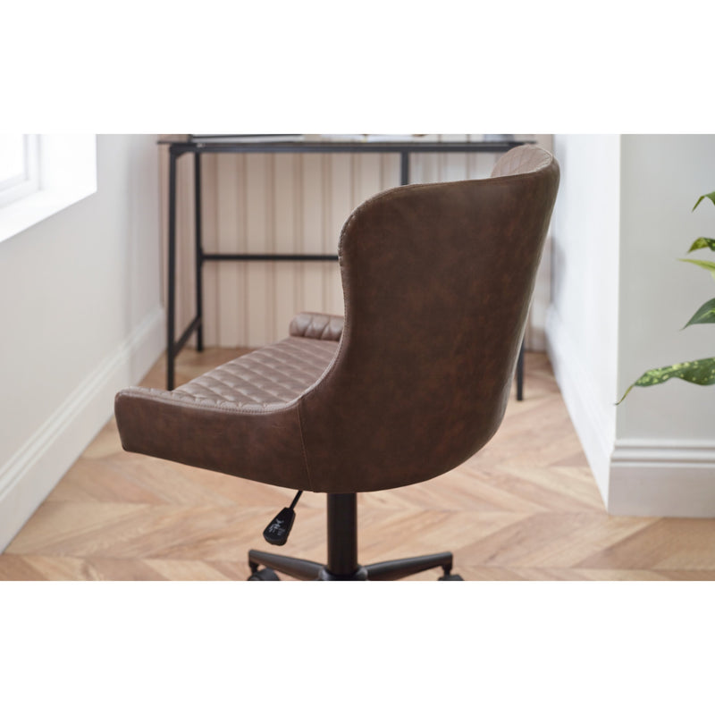 Brown office chair in a room with a desk and window.