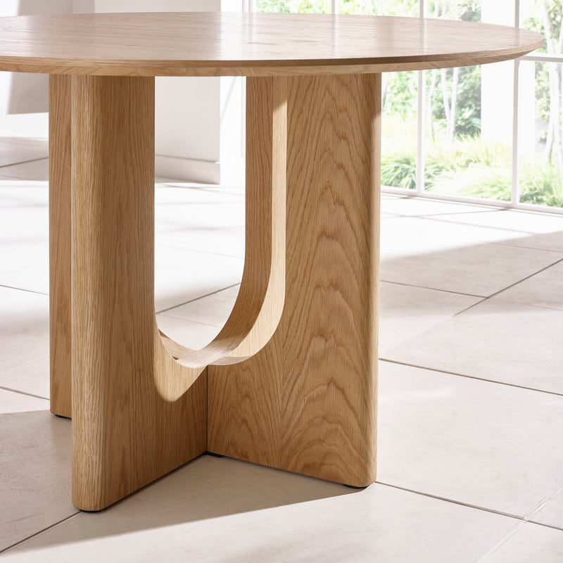 Wooden dining table with a modern design in a bright room.