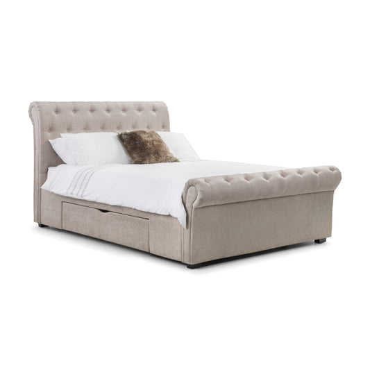 Beige upholstered bed with white bedding and a brown pillow on a white background