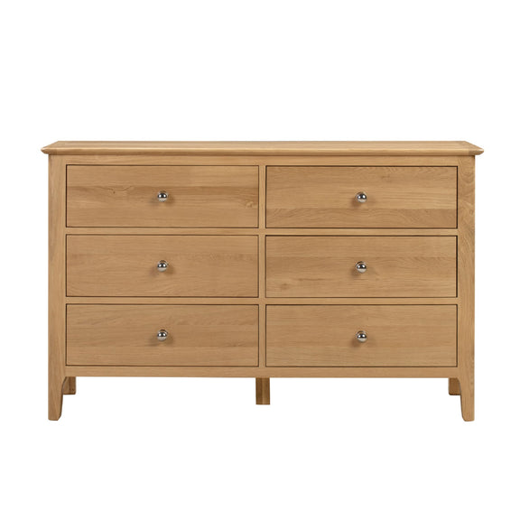 Wooden dresser with six drawers on a white background