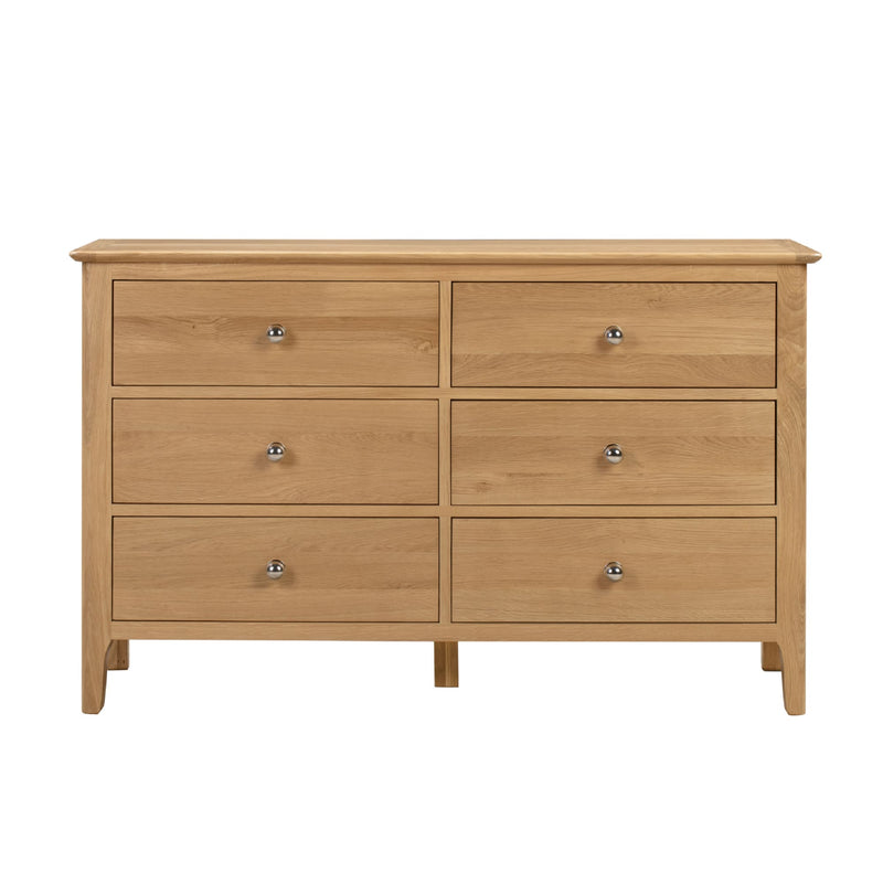 Wooden dresser with six drawers on a white background