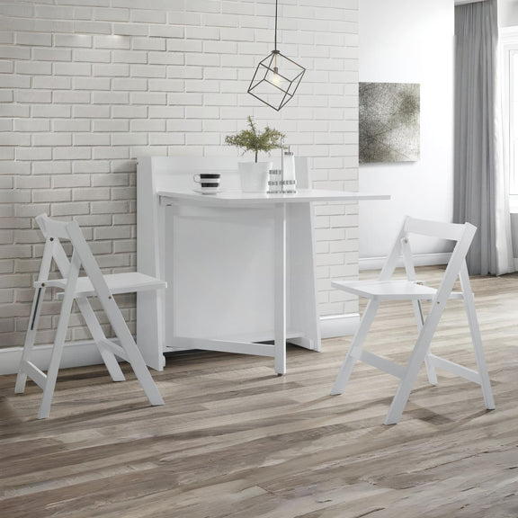 White dining table with chairs in a room with white brick walls and wooden flooring.