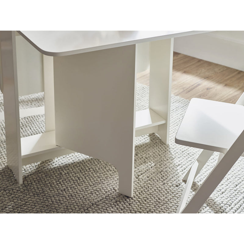 White dining table and chairs on a textured rug