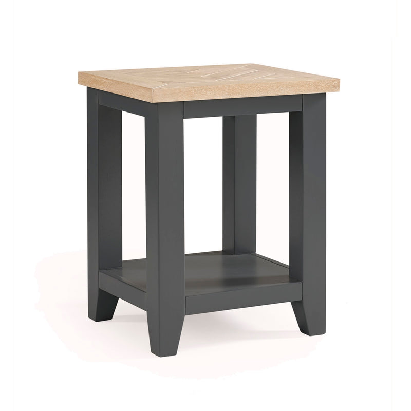 Small table with a wooden top and dark gray base on a white background