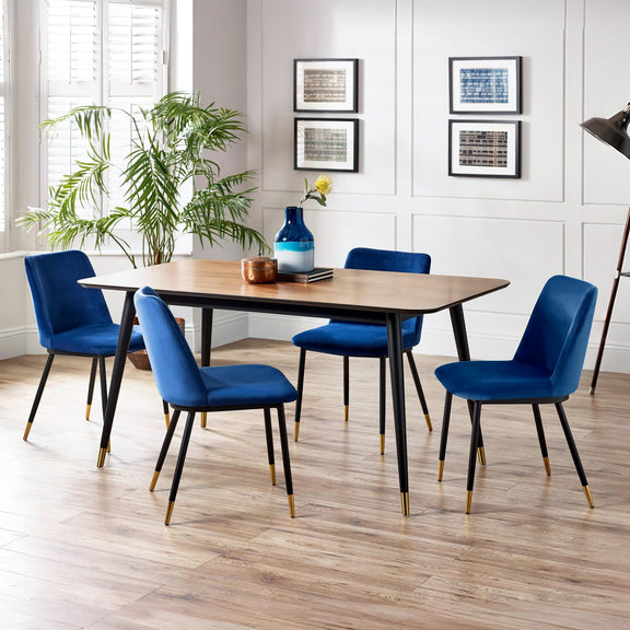 Dining room with a wooden table and blue chairs, featuring a vase and decor items.