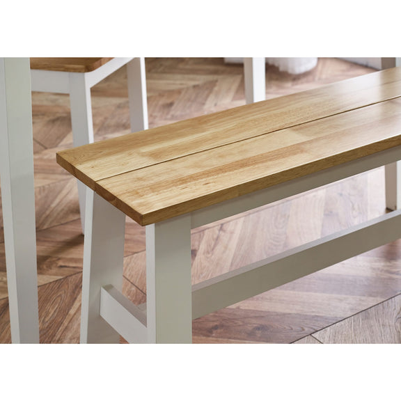 Wooden bench with white legs on a wooden floor
