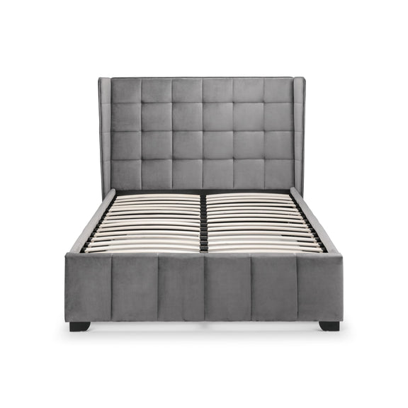 Gray upholstered bed with tufted headboard on a white background