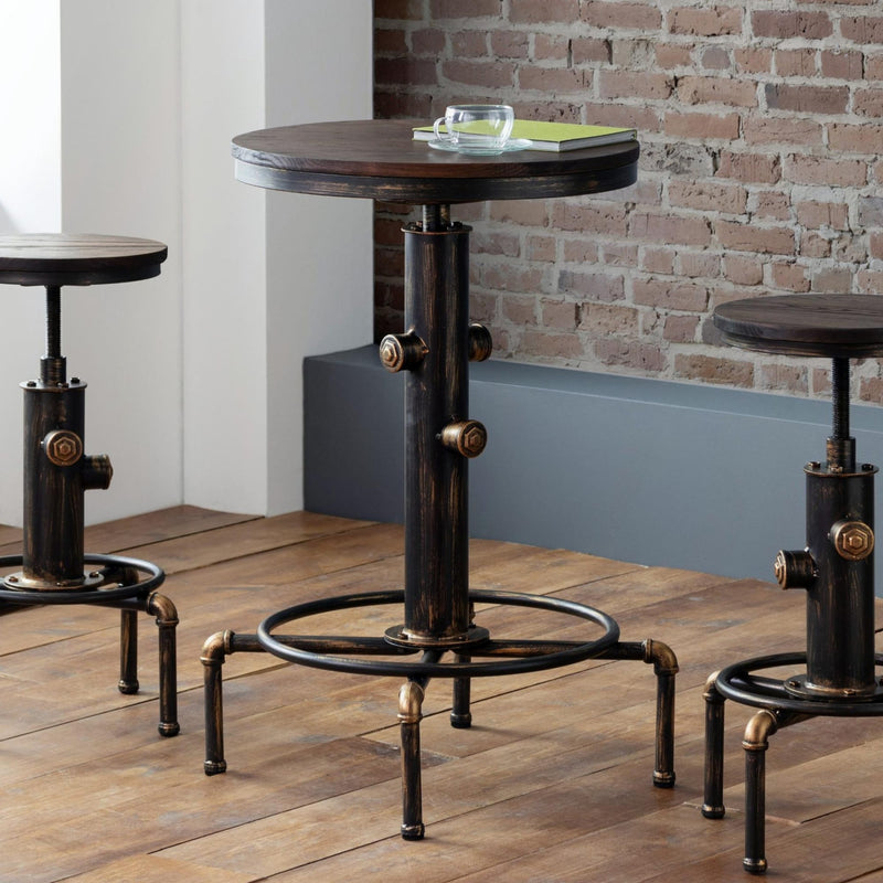 Three industrial-style tables with metal legs on a wooden floor against a brick wall.