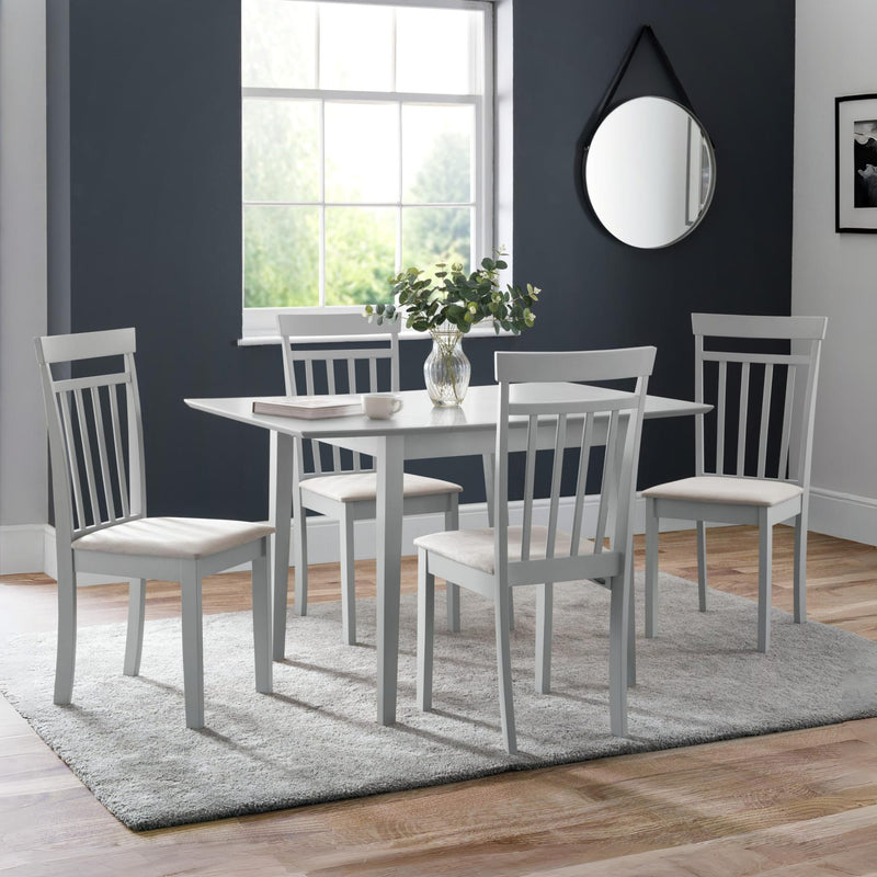 Dining room with a table and chairs in a room with a window and mirror.