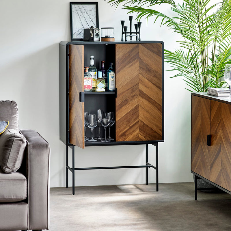 Wooden bar cabinet with drinks and glasses in a living room setting