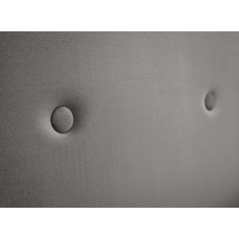 Close-up of a textured gray surface with two circular indentations.