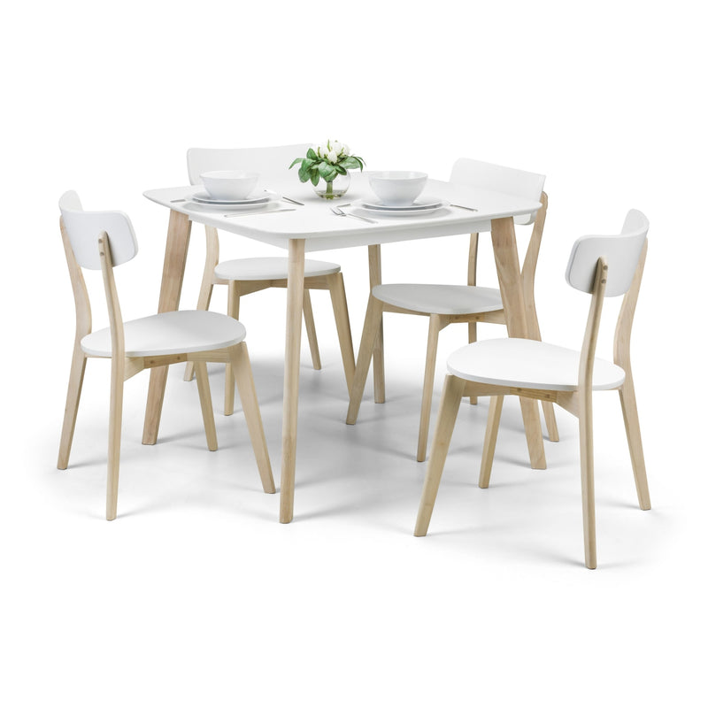 Dining table set with four chairs on a white background