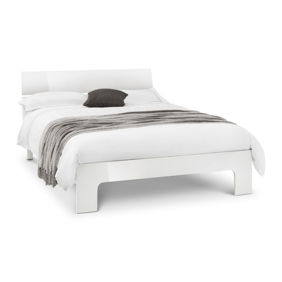 White bed with gray blanket and pillow on a white background