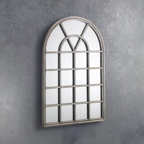 Decorative wall mirror with a window-like design on a gray wall