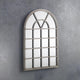 Decorative wall mirror with a window-like design on a gray wall