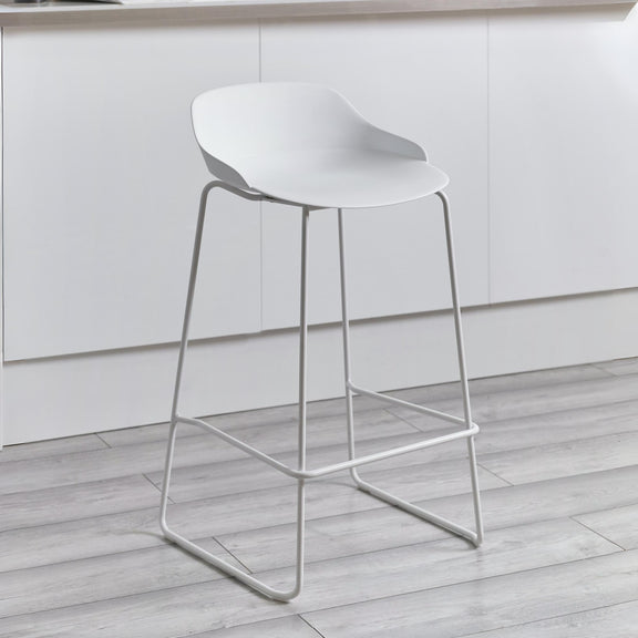 White bar stool on a wooden floor with a neutral background