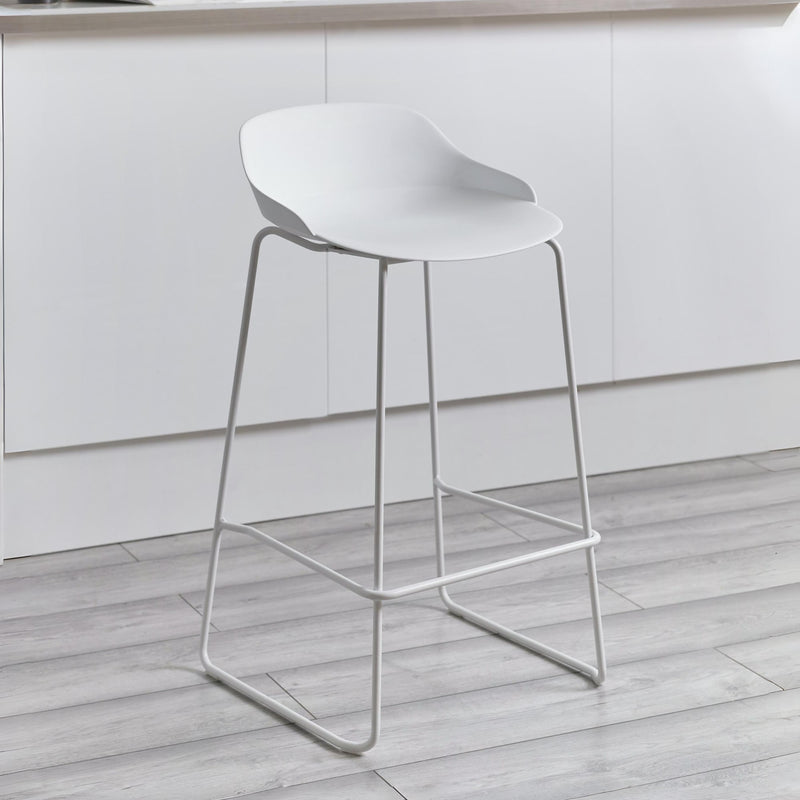 White bar stool on a wooden floor with a neutral background