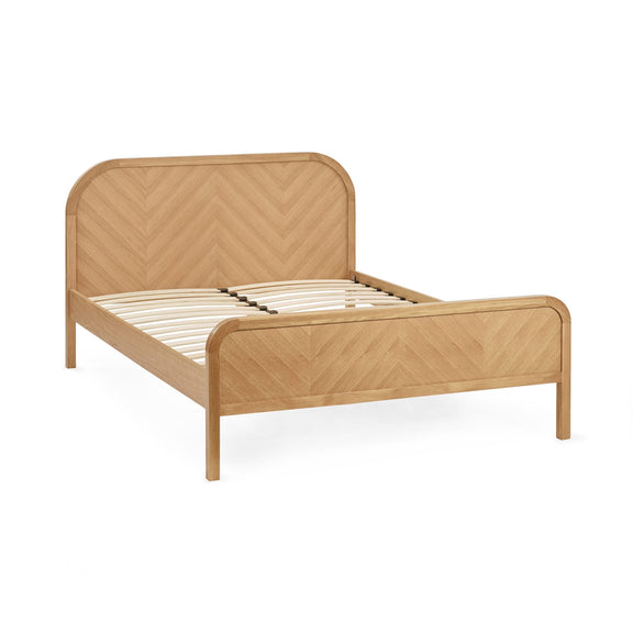 Wooden bed frame with chevron pattern on a white background