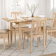Dining table set with chairs and plates in a bright room