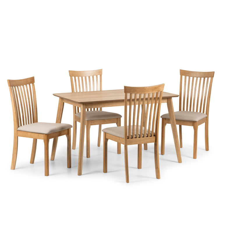 Wooden dining table with four matching chairs on a white background