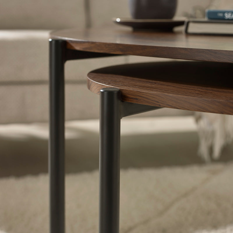 Close-up of a wooden side table with metal legs on a neutral background