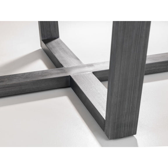 Close-up of a modern furniture leg with cross-brace design on a white background