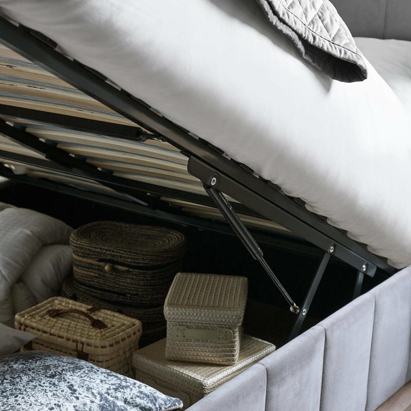Underbed storage with wicker baskets and a mattress lift mechanism.