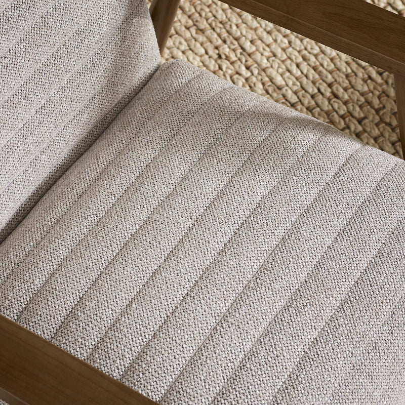 Close-up of a textured gray stair runner on wooden stairs.