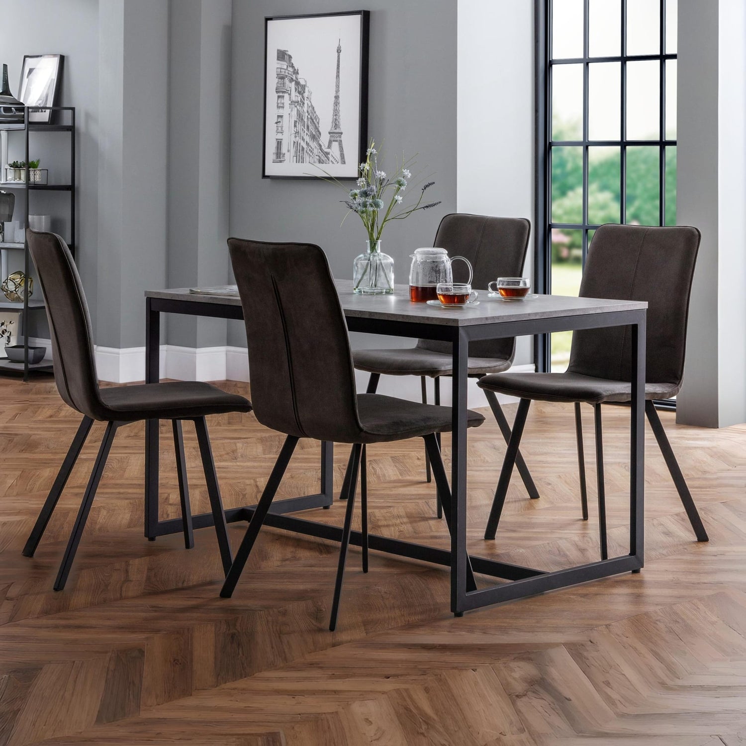 Dining room with a table and chairs on a wooden floor.