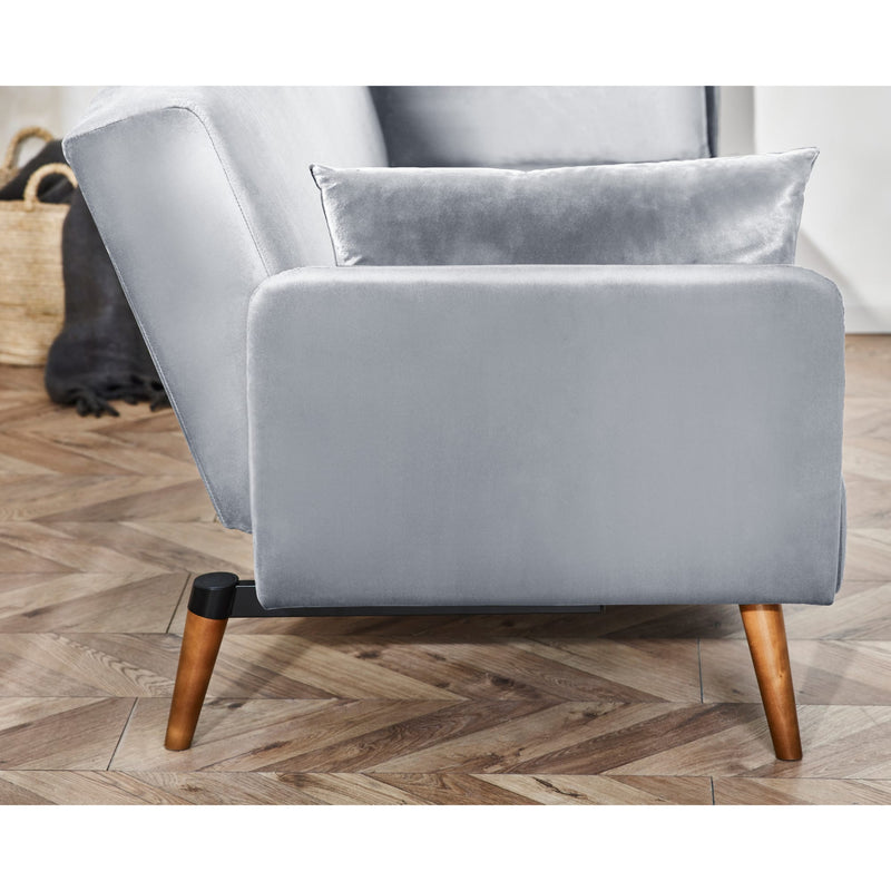 Gray armchair with wooden legs on a wooden floor