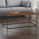 Wooden coffee table with a metal frame in a living room setting.