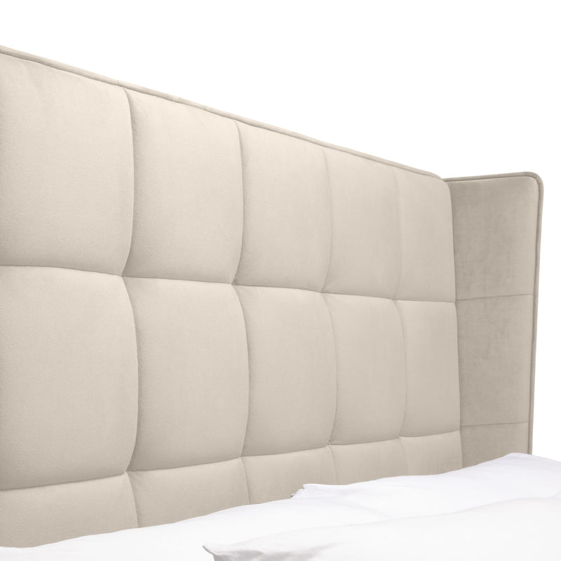 Beige quilted headboard on a white background