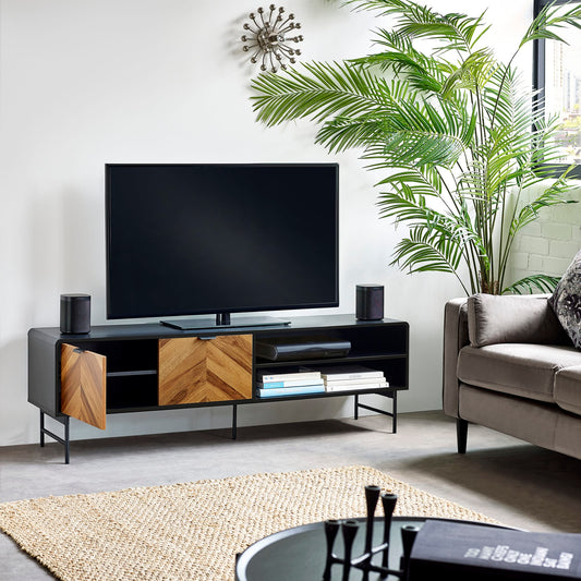 Modern living room with a TV stand, sofa, and decorative elements.