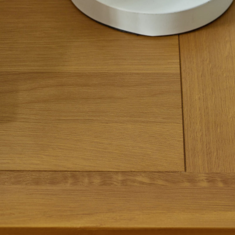 Close-up of a wooden surface with a metallic object partially visible
