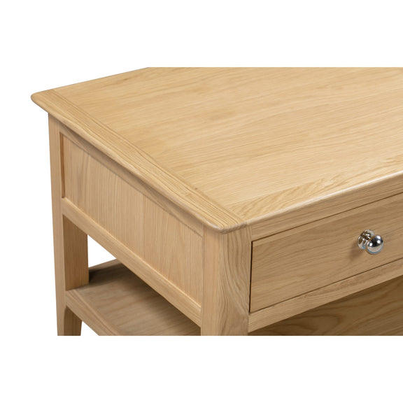 Wooden side table with a drawer and shelf on a white background
