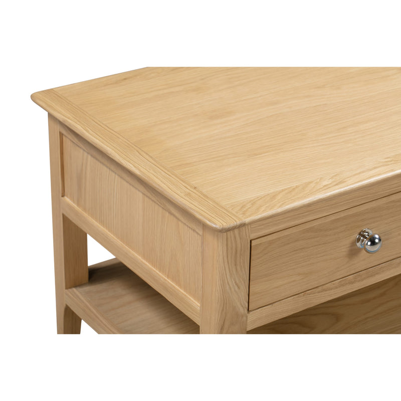 Wooden side table with a drawer and shelf on a white background