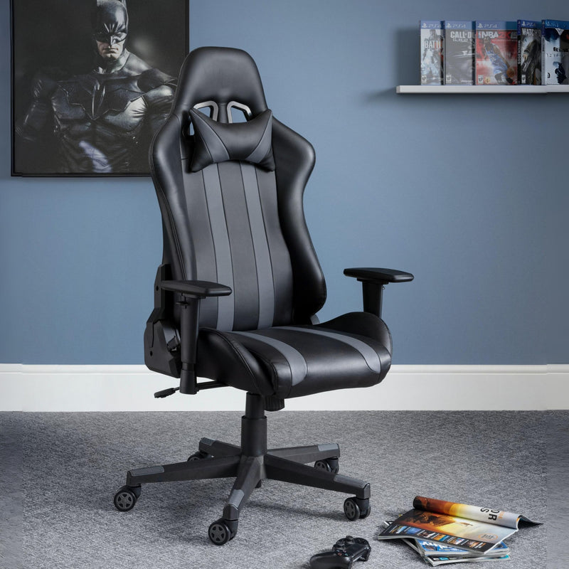 Black and gray gaming chair in a room with a superhero poster on the wall.