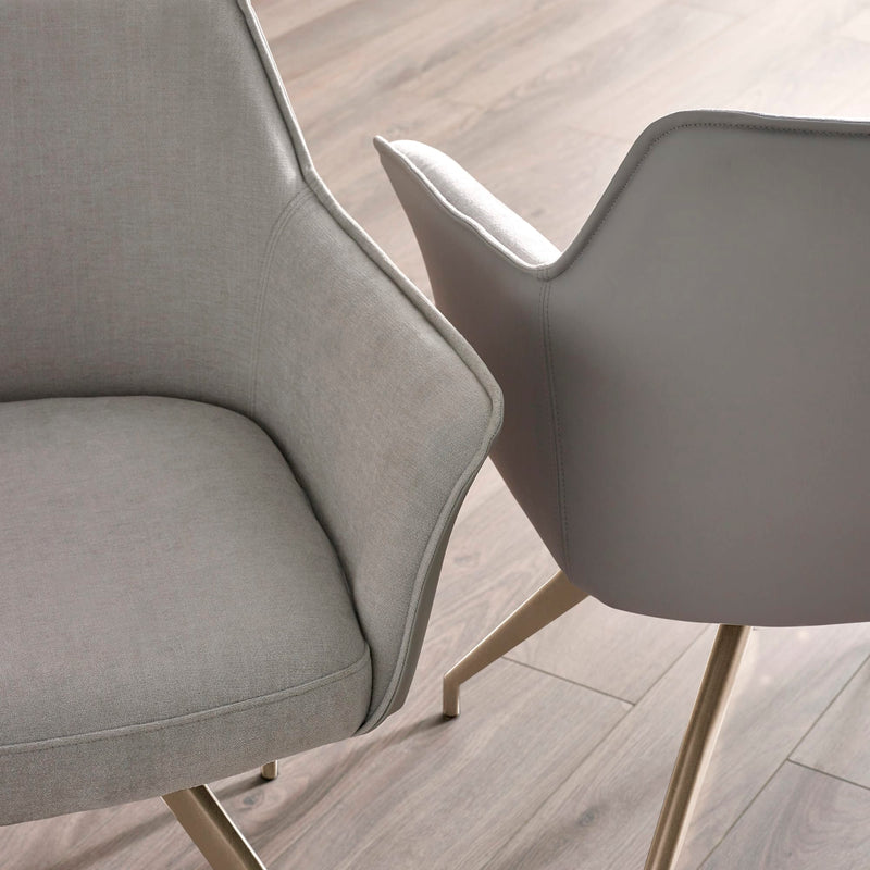 Two modern gray chairs on a light wood floor.