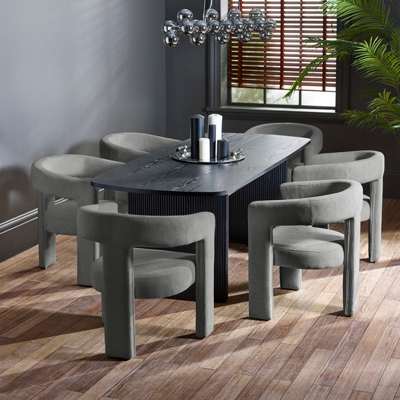 Dining room with a dark wooden table and gray chairs on a wooden floor.