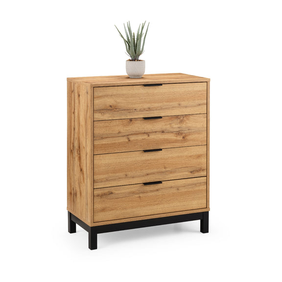 Wooden dresser with four drawers and a potted plant on top against a white background