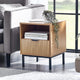 Wooden side table with books and a plant in a living room setting