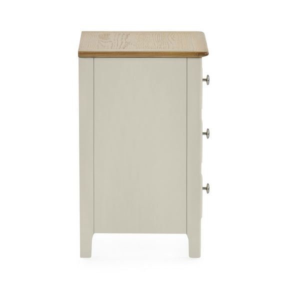 Rear view of white wooden three drawer bedside table