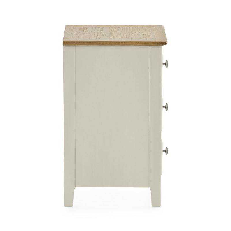 Rear view of white wooden three drawer bedside table