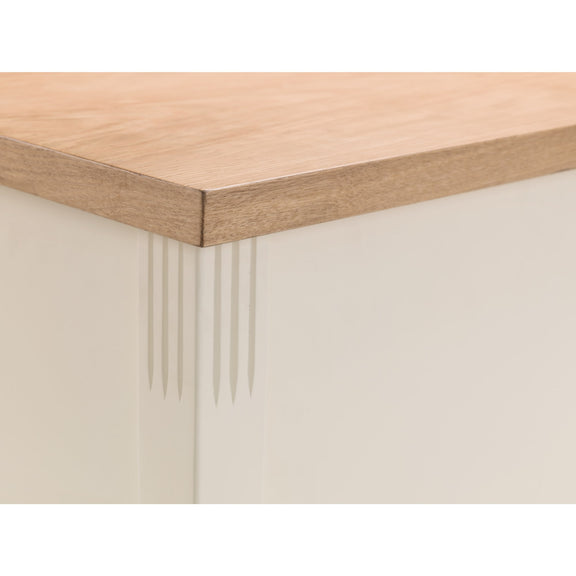 Close-up of a wooden table corner with a white base