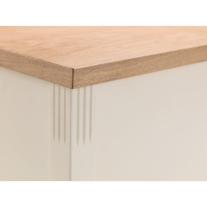 Close-up of a wooden table corner with a white base