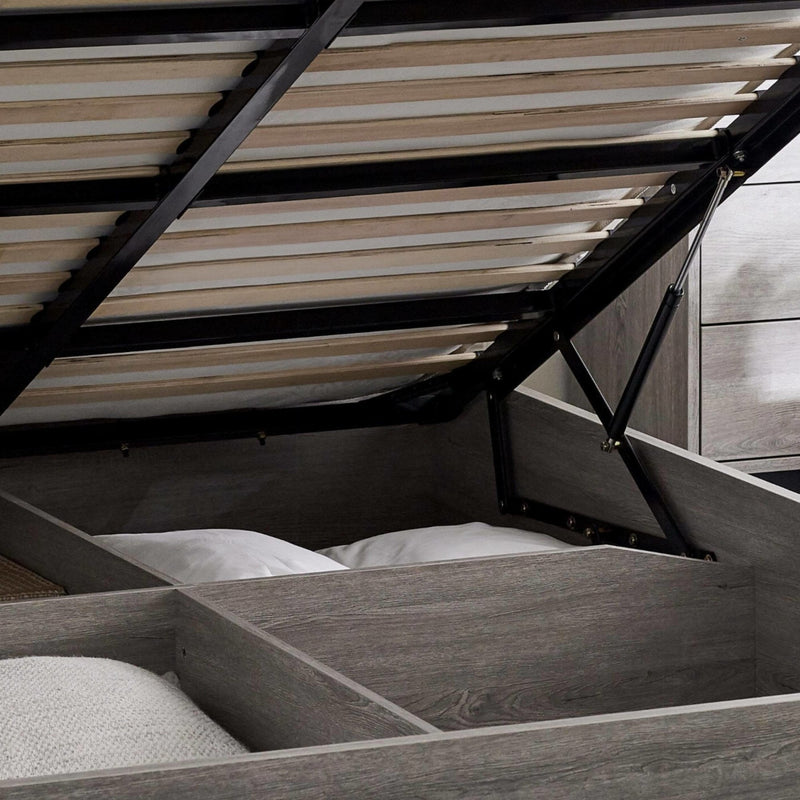 Wooden bed with open drawers revealing storage space underneath.
