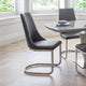Modern black chairs with metal legs in a dining room setting.