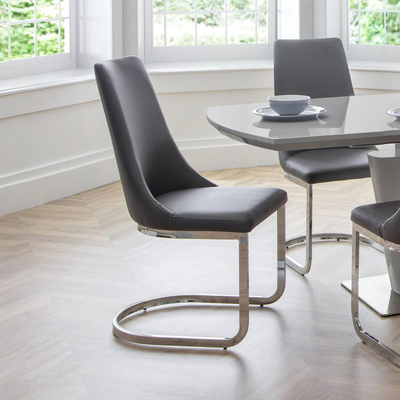Modern black chairs with metal legs in a dining room setting.