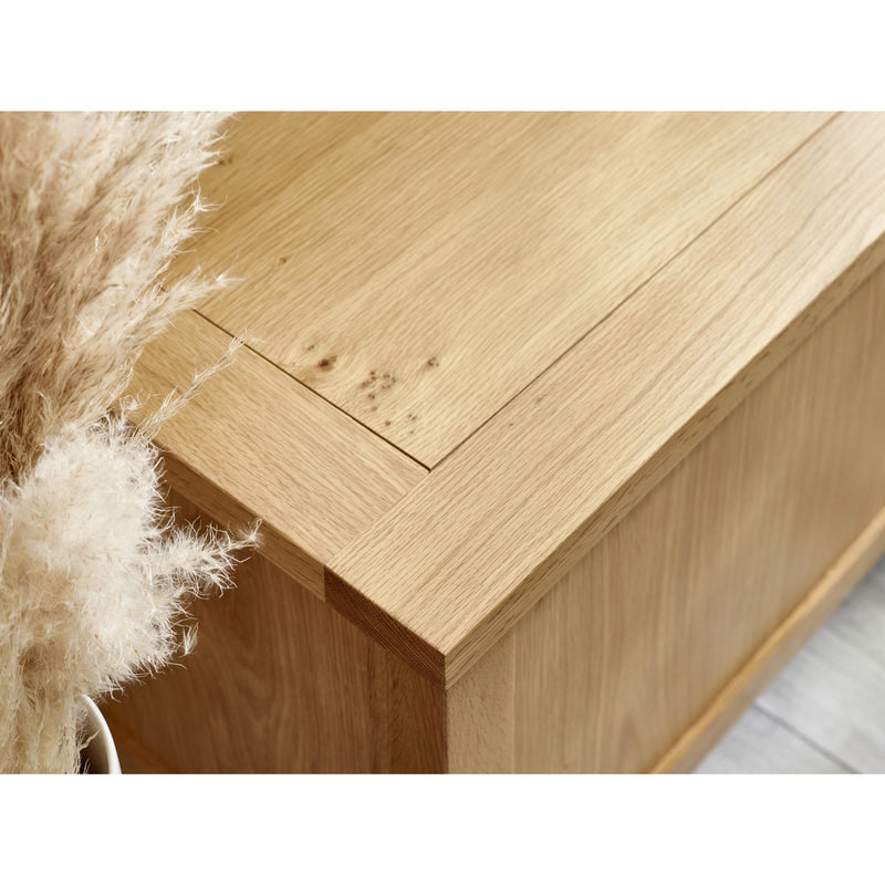 Close-up of a wooden surface with natural wood grain and a soft white background.